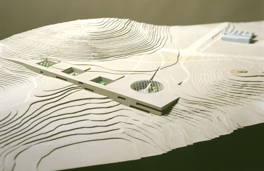 Photo of the architect's model of the Paranal Residencia and Offices. The building is fully integrated into the landscape. Its south and western facades emerge from the ground, providing a view from the bedrooms, offices and restaurant towards the Pacific Ocean.