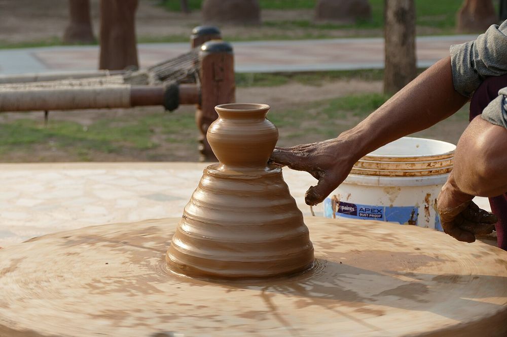 Pottery at the Chokhi Dhani Resort Panchkula, Haryana, India. The throwing of small objects on a pottery wheel.