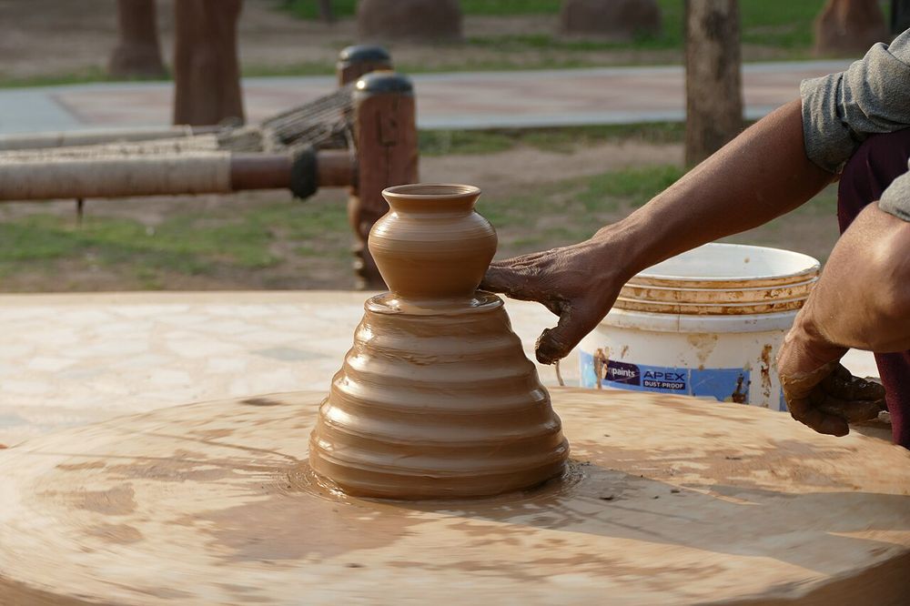 Pottery at the Chokhi Dhani Resort Panchkula, Haryana, India. The throwing of small objects on a pottery wheel.