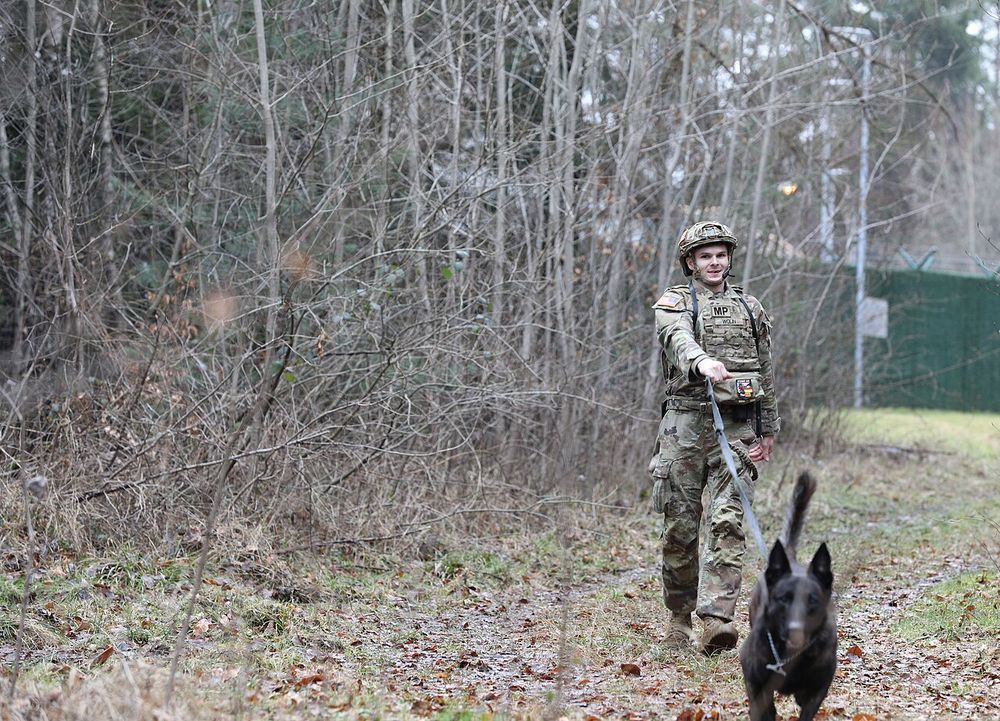 U.S. Army Pfc. Wolin Tobey, a military working dog handler 100th Military Working Dog Detachment, training for the military working dogs on Ammunition Depot Europe–Miesau, Germany, on Feb. 20th, 2026. This demonstrates simulated training on looking for explosives. (U.S. Army photo by Pvt. Kaiden Sil