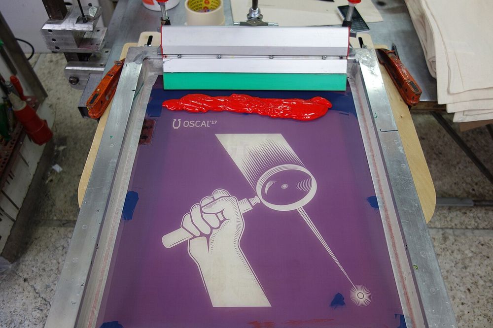 Photos from the production process of the promo materials (posters and tote bags) of the fourth edition of Open Source Conference Albania that takes place in Tirana Albania in the second weekend of May 2017. The materials were printed using the silkscreen method.