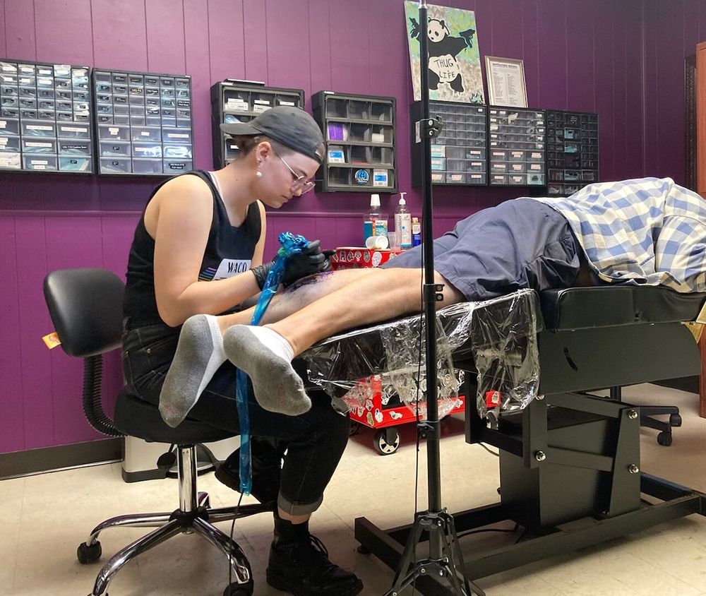 Tattooing a hedgehog in lederhosen in studio Tattoo Jenna Haas
